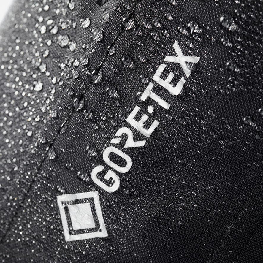 Close up of a REV'IT! Vertical GTX motorcycle jacket, with water beading off the GORE-TEX logo and material