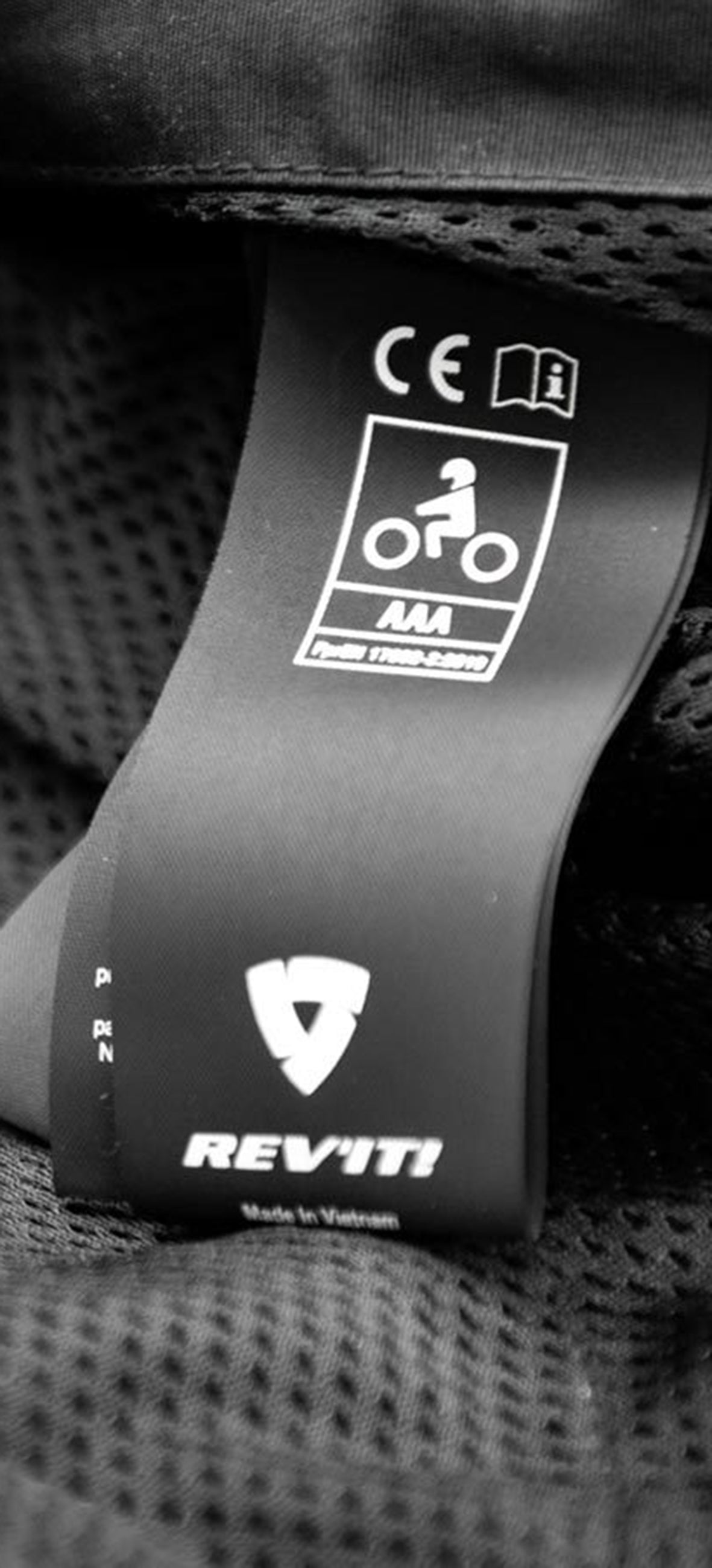 Close-up image of a CE Certification Label inside a piece of REV'IT! motorcycle apparel