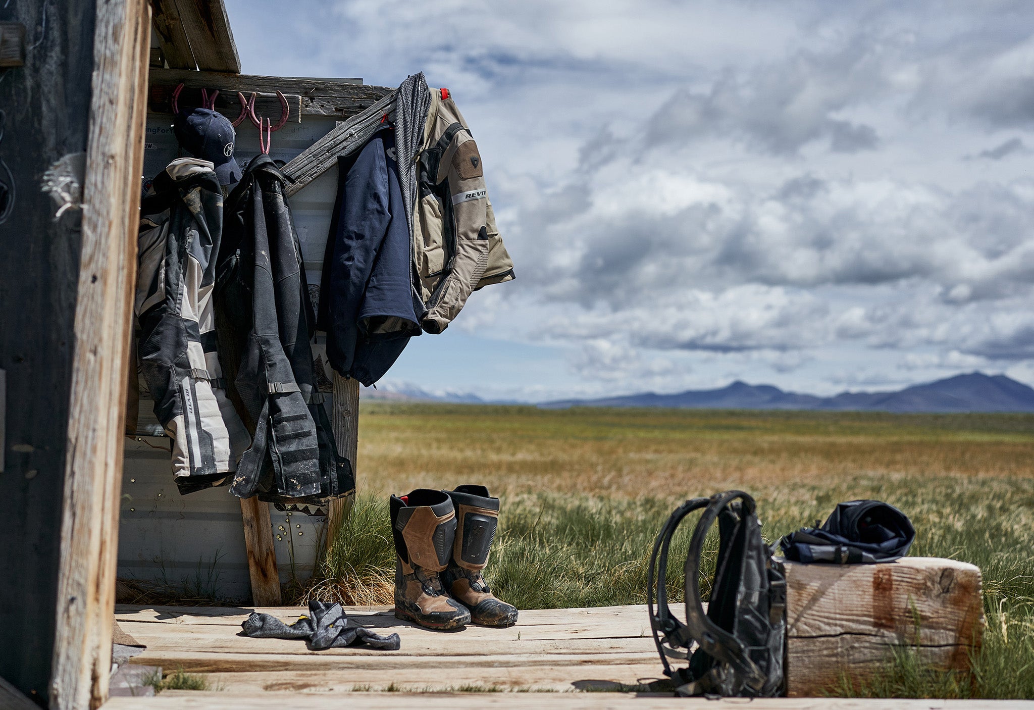 Lifestyle image showing a range of REV'IT! motorcycle gear hanging up in a shed